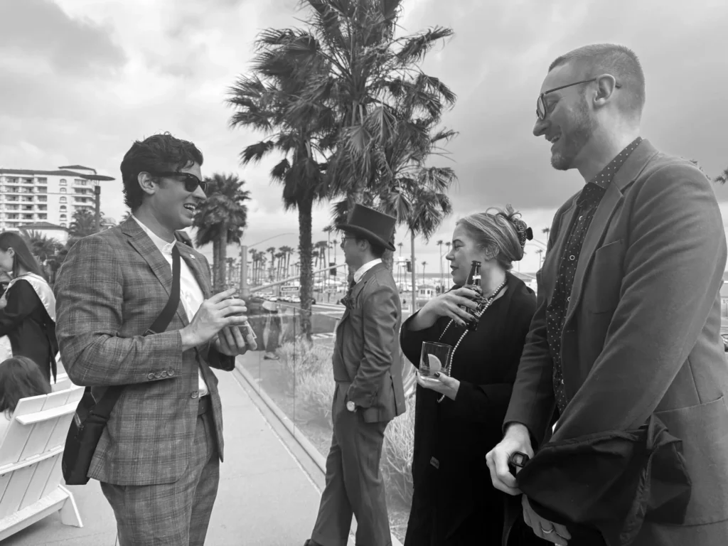 Shayne Slauter performing strolling mentalism for guests laughing at an oceanfront event