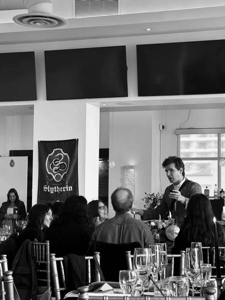 Shayne Slauter performing at a guest table during a wedding reception dinner